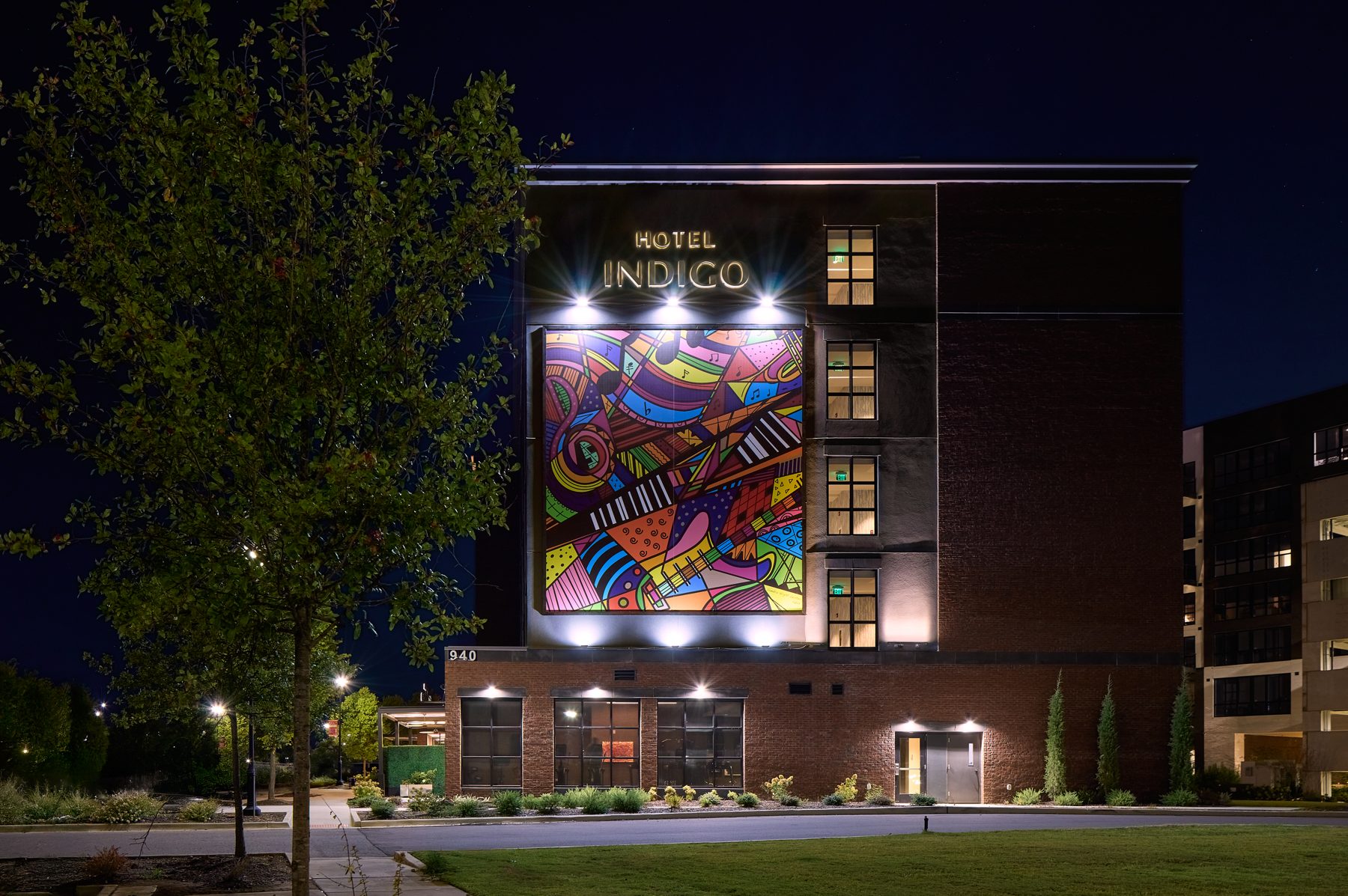 Hotel Indigo Huntsville at night with its colorful mural